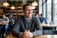 40s man smiling in a restaurant